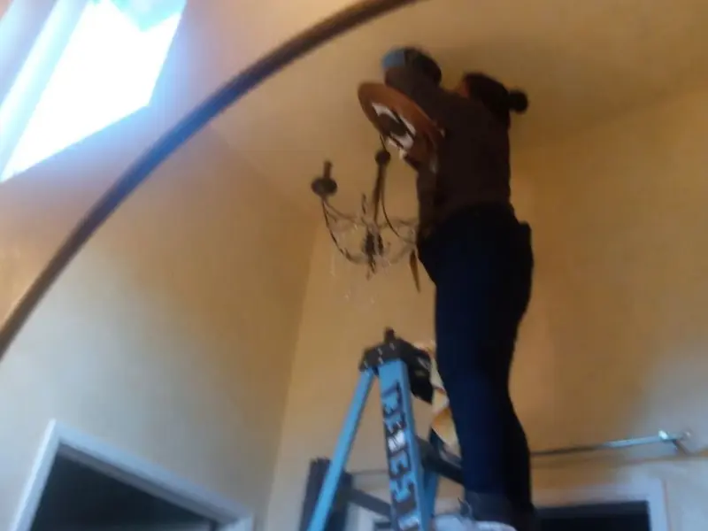 Electrician installing a chandelier in a Ahtanum residence